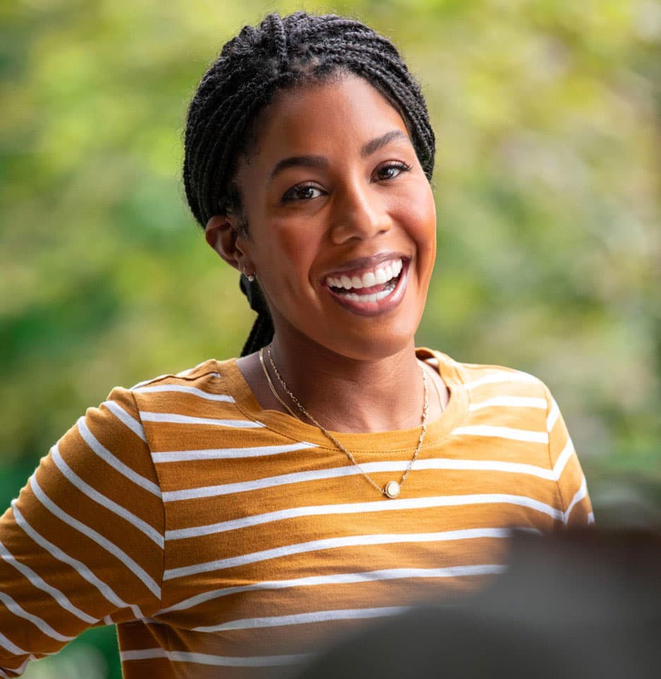 Happy woman is smiling after her Invisalign treatment
